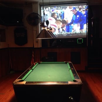 Tee Dee's Tavern - a pool table in front of a tv - Pubs Near Me - Glendale, New York