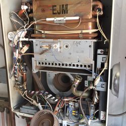 David Mallek Plumbing - Servicing a tankless water heater.
