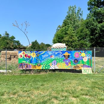 Three Part Harmony Farm - a fence with a colorful mural - CSA Near Me