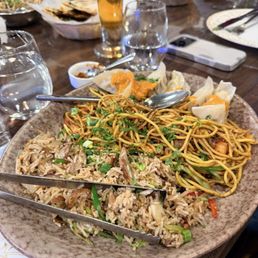 Combination plate: Duck fried rice, chicken Chowmein, and chicken momo Combination plate: Duck fried rice, chicken Chowmein, and chicken momo