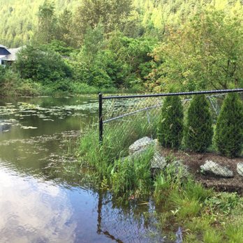 Log Escape - Portion of backyard & view of Miami River. - Vacation Rentals Near Me - Harrison Hot Springs, British Columbia