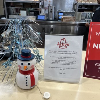 Arby's - a snowman next to a menu sign - Fast Food Near Me - Neptune, New Jersey
