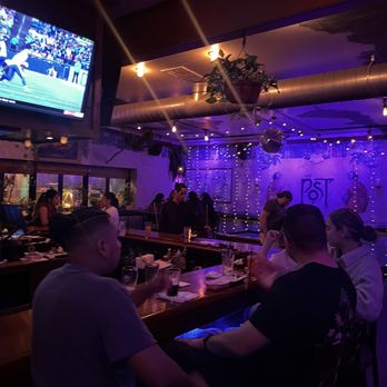 The Post Bar - a group of people sitting at a bar - Sports Bars Near Me - Fairview, New Jersey