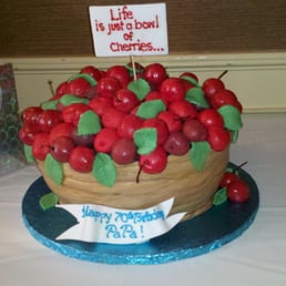 Edible art for my father's 70th Birthday.  A delicious chocolate cake with cherry butter cream filling and rice crispie cherries