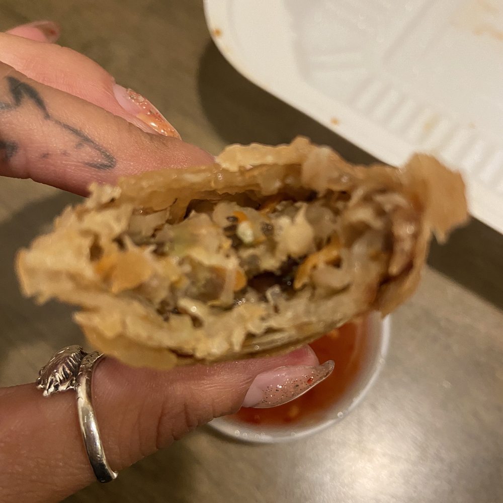 Noodle Bar - a person's hand holding a sandwich - Vietnamese Near Me - Seaside, California Noodle Bar - a person's hand holding a sandwich - Vietnamese Near Me - Seaside, California