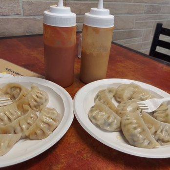 Hamro Bhim's Cafe - two plates of dumplings and a bottle of ketchup - Himalayan/Nepalese Near Me - Jackson Heights, New York Hamro Bhim's Cafe - two plates of dumplings and a bottle of ketchup - Himalayan/Nepalese Near Me - Jackson Heights, New York