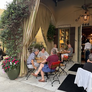 Osteria Tulia - People sitting and talking at a table 1 hour after they paid the check. - Italian Near Me - Naples, Florida Osteria Tulia - People sitting and talking at a table 1 hour after they paid the check. - Italian Near Me - Naples, Florida