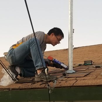 Smart Construction - a man working on a roof - General Contractors Near Me