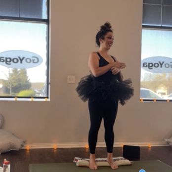 GoYoga - Powell - Krista in her amazing swan yoga attire with swan balloons/decorations nearby. - Yoga Near Me - Powell, Ohio