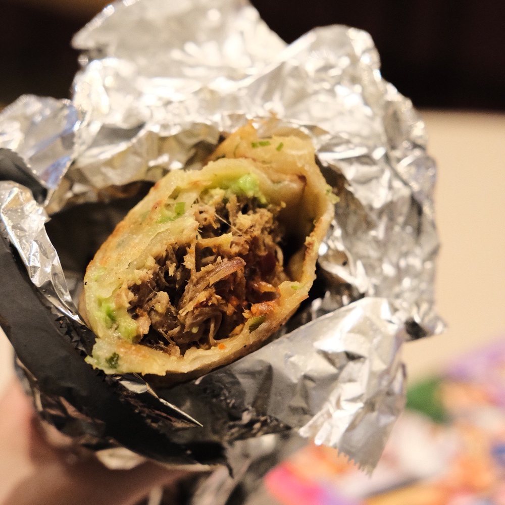 Forsyth Fire Escape - a hand holding a burrito - Asian Fusion Near Me - New York, New York Forsyth Fire Escape - a hand holding a burrito - Asian Fusion Near Me - New York, New York