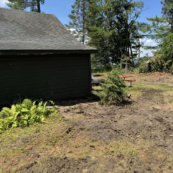 MC Land Services - After of the garage with stump removed! - Tree Services Near Me - Bemidji, Minnesota