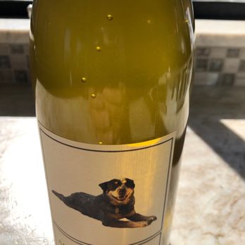 Devitt Winery - a bottle of wine with a dog on it - Wineries Near Me - Jacksonville, Oregon