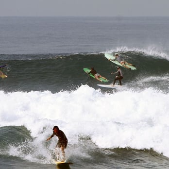 One Wave Surf School - About a year and a half after my first lesson, I am in the background in black with a hat on. - Surf Schools Near Me - Manhattan Beach, California