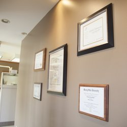 JL Dental - Our doctors' certificates displayed on the JL Dental wall