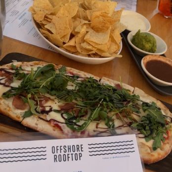 Offshore Rooftop - Proschuitto arugula pizza (mid) and chips and dip trio - New American Near Me - Chicago, Illinois