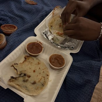 Pupuseria San Miguel - a person putting sauces on a tortilla - Salvadoran Near Me - Arcata, California