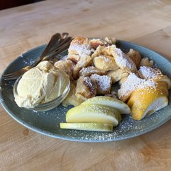 Taverne beim Olivenbauer - Kaiserschmarren. Fresh apple pancakes with fresh slices of apple and orange, Bavarian vanilla ice cream and powdered sugar.