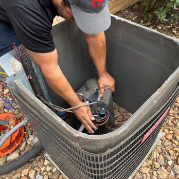 CG Service Pros - Our technician Eric fixing an outside condenser. - Heating & Air Conditioning/HVAC Near Me - Austin, Texas CG Service Pros - Our technician Eric fixing an outside condenser. - Heating & Air Conditioning/HVAC Near Me - Austin, Texas