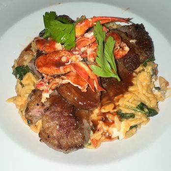 Christopher's Kitchen and Bar - MEDITERRANEAN SURF & TURF sliced ribeye, lobster meat, orzo, spinach, tomatoes, mascarpone, red wine sauce - American Near Me - Woonsocket, Rhode Island Christopher's Kitchen and Bar - MEDITERRANEAN SURF & TURF sliced ribeye, lobster meat, orzo, spinach, tomatoes, mascarpone, red wine sauce - American Near Me - Woonsocket, Rhode Island