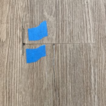 California Carpets & Design Center - a piece of blue tape taped to a wood floor - Carpeting Near Me - Rocklin, California