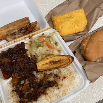 Bikkle Jamaican Restaurant - Oxtail with white rice, spicy beef pattie, jerk chicken egg rolls, and coco bread. Yummmm - Caribbean Near Me - Austin, Texas