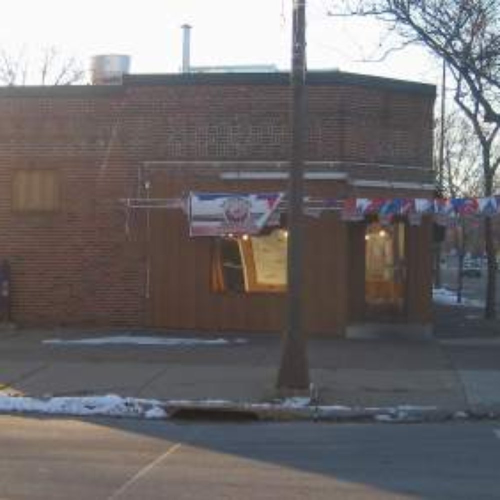 a corner of a brick building on a street corner a corner of a brick building on a street corner