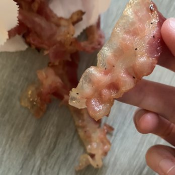 Dunkin' - a hand holding a piece of bacon - Donuts Near Me - Lejeune, North Carolina Dunkin' - a hand holding a piece of bacon - Donuts Near Me - Lejeune, North Carolina