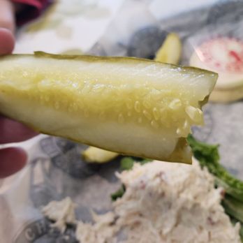 Chicken Salad Chick - a person holding a pickle - Southern Near Me - Buford, Georgia
