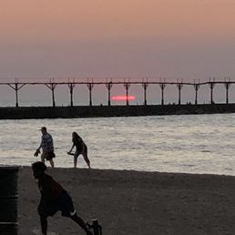 people playing baseball on the beach