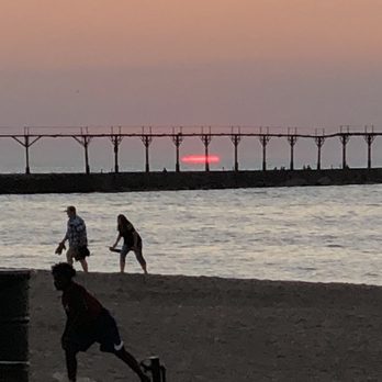Sunset Grille - people playing baseball on the beach - American Near Me - Michigan City, Indiana