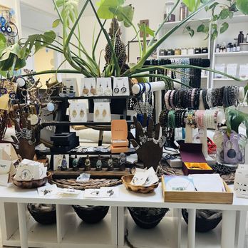 We Are Sacred Roots - a table of jewelry and plants - Herbs & Spices Near Me We Are Sacred Roots - a table of jewelry and plants - Herbs & Spices Near Me