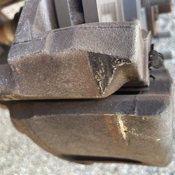 Marks Auto Service - Damaged caliper (was hitting wheel) - A photograph shows a brake caliper with a noticeable crack or break, likely from wear or damage, on a vehicle component. - Auto Repair Near Me - Roscoe, Illinois