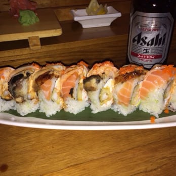 Densetsu - Lion King Roll- shrimp tempura, crab & avocado  inside - topped with salmon, eel, masago and a delicious creamy sauce. HUGE! - Japanese Near Me - Plano, Texas