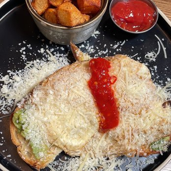 Social52 - Avocado toast with sunny side up eggs and a side of home fries. - New American Near Me - Richmond, Virginia
