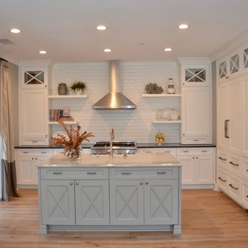Studio Spinola - a kitchen with white cabinets and a center island - General Contractors Near Me - Hilton Head Island, South Carolina Studio Spinola - a kitchen with white cabinets and a center island - General Contractors Near Me - Hilton Head Island, South Carolina