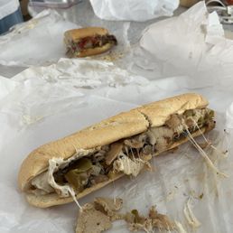 Chicken cheesesteak in front, beef cheesesteak with spicy peppers back Chicken cheesesteak in front, beef cheesesteak with spicy peppers back