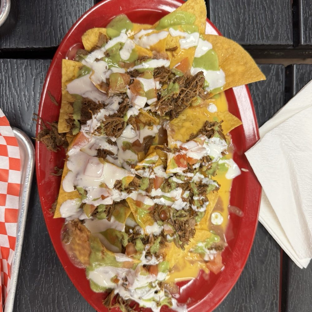 Cielito Lindo Taqueria - Nachos with birria, nacho cheese, tomatoes, avovado sauce and Parmesan cheese - Mexican Near Me - Reno, Nevada Cielito Lindo Taqueria - Nachos with birria, nacho cheese, tomatoes, avovado sauce and Parmesan cheese - Mexican Near Me - Reno, Nevada