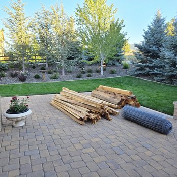 A & D General Services - Cedar split rails and welded wire mesh neatly organized on the patio - Fences & Gates Near Me