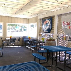 Carneros Deli - Cute covered seating area with flowers, potted succulents, and race hoods (of course).