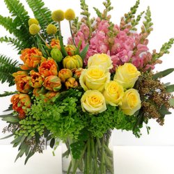 Floral by Victoria - This jaw-dropping beauty features premium yellow roses, pink snap dragons, orange tulips, and more.