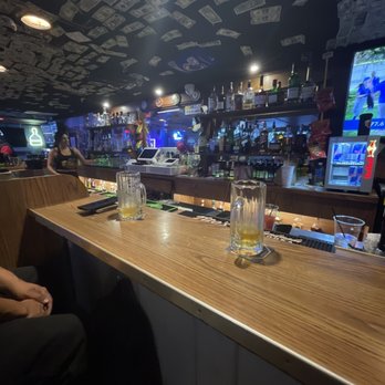 The Thirsty Ox - a man sitting at a bar - Cocktail Bars Near Me - Oxnard, California