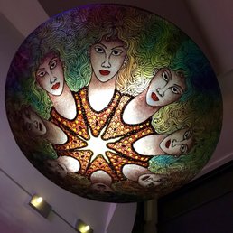 a colorful ceiling light with faces on it