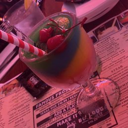 a colorful cocktail with strawberries in it