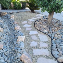 Healthy Turf Landscape Management - Dry river bed with flagstone walkway