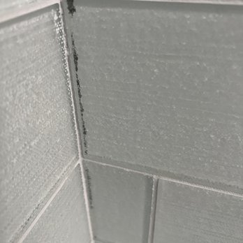 Task Flooring - the corner of a tiled bathroom - Flooring Near Me