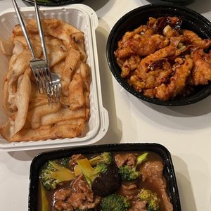Photo of Moon Palace Express - Chicago, IL, United States. Top left clockwise: fish fillet string beans, garlic peapod sprouts, orange chicken, beef and broccoli chow fun with sauce on the side