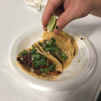 Taqueria Mis Marias - a person dipping a lime into a taco - Mexican Near Me - Waco, Texas Taqueria Mis Marias - a person dipping a lime into a taco - Mexican Near Me - Waco, Texas