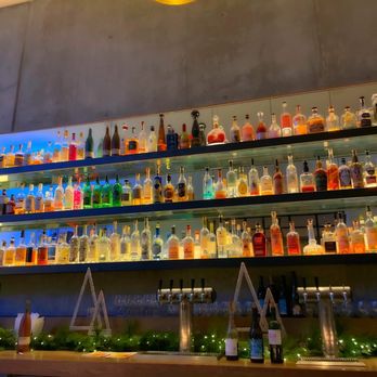 Written Hand - bottles of alcohol lined up on shelves - Bars Near Me - Los Angeles, California Written Hand - bottles of alcohol lined up on shelves - Bars Near Me - Los Angeles, California