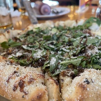 The Village Idiot - a pizza on a metal platter - American Near Me - Revelstoke, British Columbia The Village Idiot - a pizza on a metal platter - American Near Me - Revelstoke, British Columbia