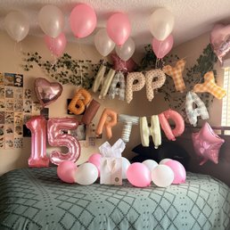 Happy Birthday letter balloons, 15 number balloons, Star and Heart balloons, and single pink and white balloons.